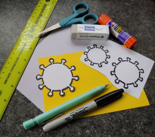 Zine making supplies are pictured: ruler, scissors, glue stick, eraser, drawings, pencil, sharpie