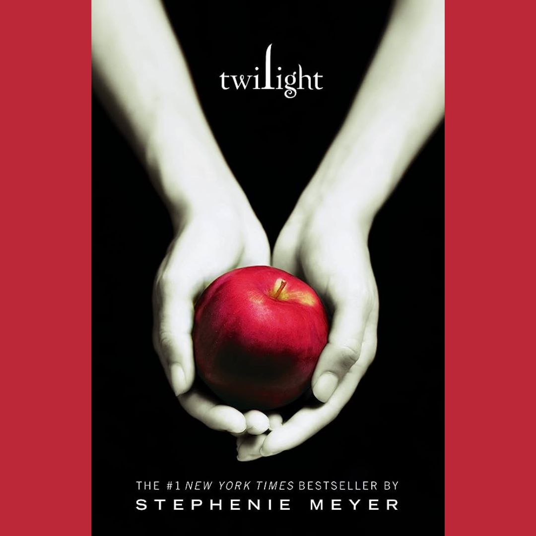 the cover of twilight by stephanie meyer. pale hands hold a red apple.